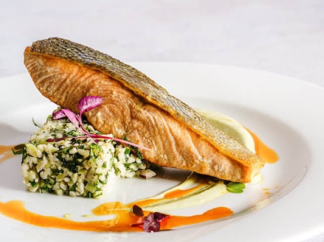 Salmon fillet on plate on bed of rice